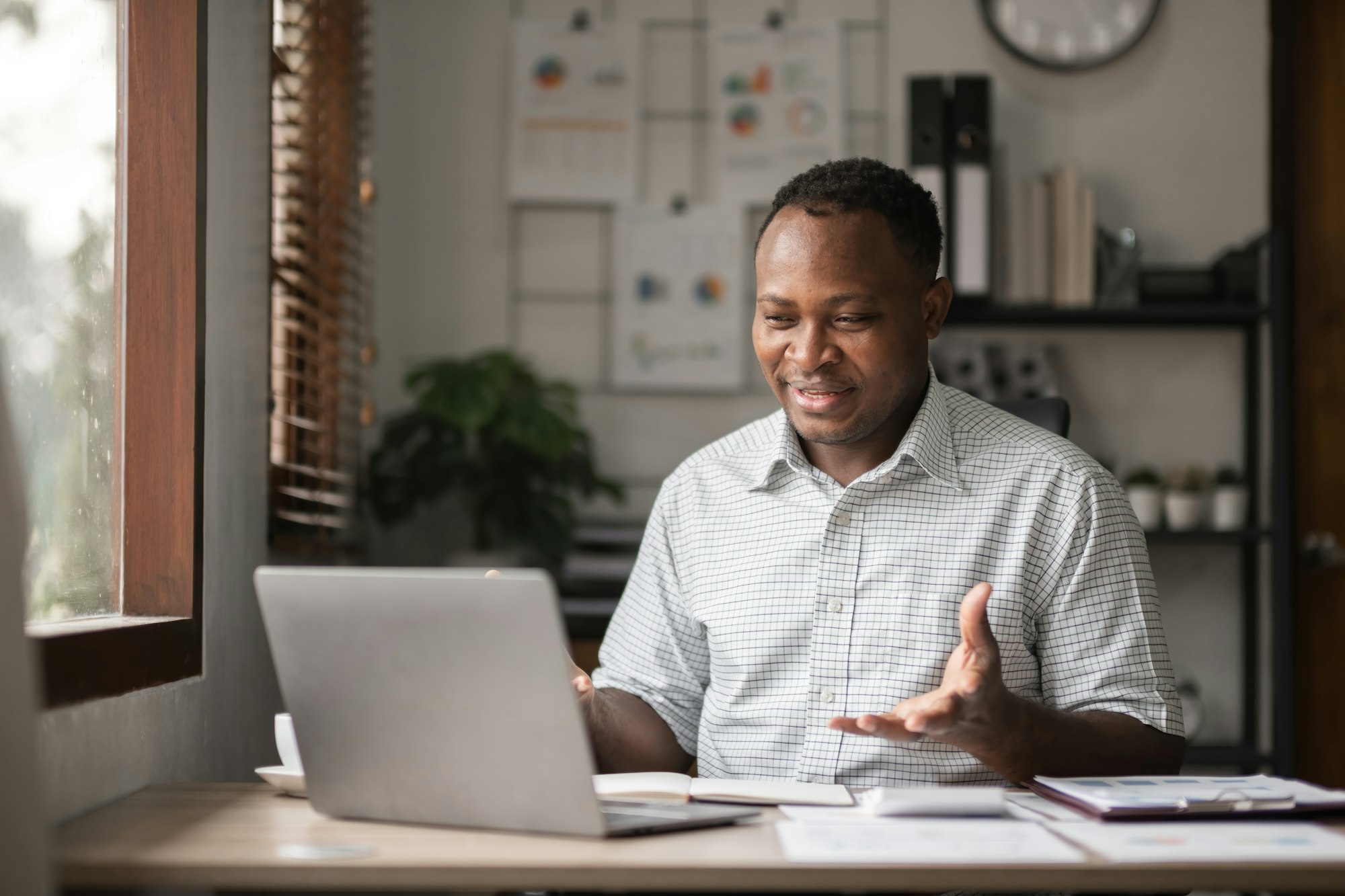 African American businessman working with laptop, online meeting and presenting results via Zoom African American businessman working with laptop, online meeting and presenting results via Zoom